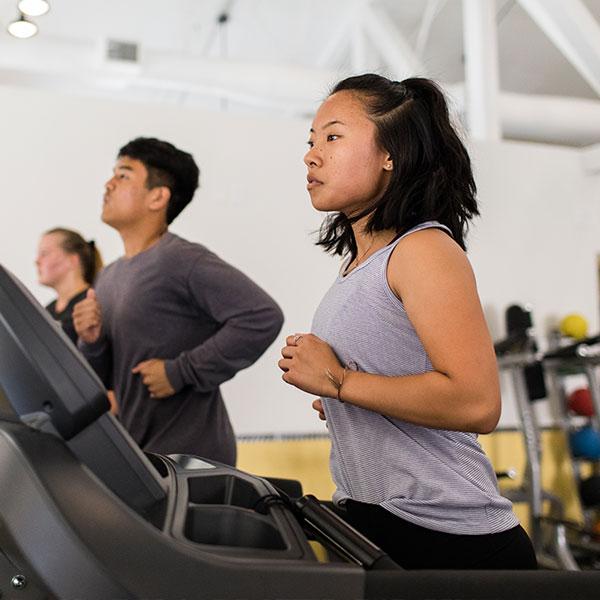 Female student exercising in the CU Active gym