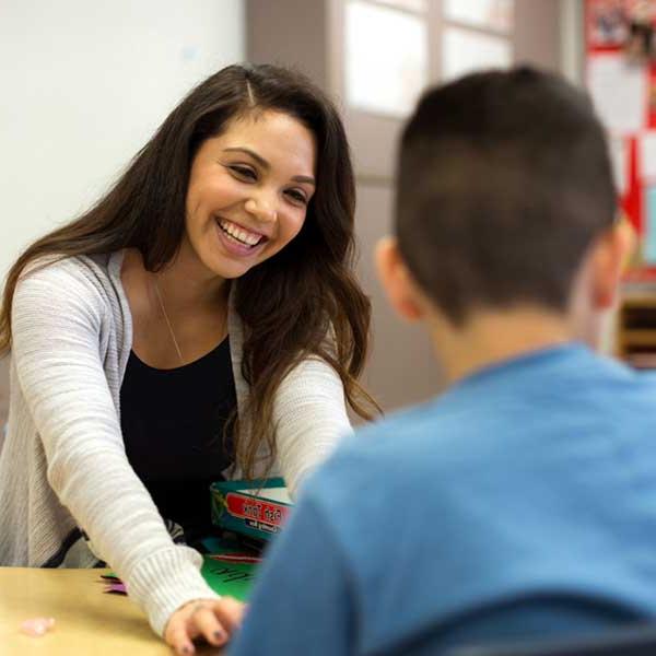 Female teacher teaching a student